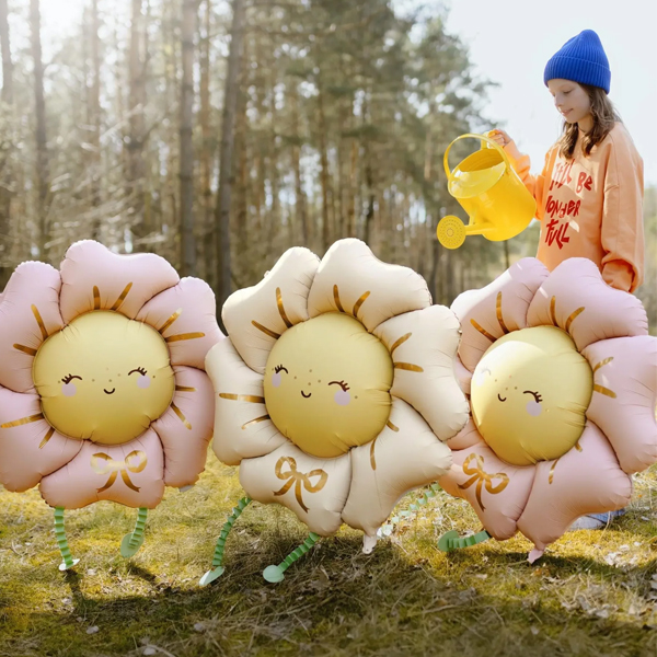 An inflated blush pink walking flower balloon with dangling green legs standing upright, prepared for delivery across London by The London Balloon Shop by Oscar's Den.